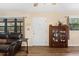 Bright living room with a ceiling fan, hardwood flooring, and display cabinet at 14100 Ne 46Th St, Silver Springs, FL 34488