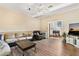 Cozy living room featuring hardwood floors, comfortable seating, and natural light at 14100 Ne 46Th St, Silver Springs, FL 34488