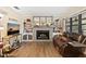 Cozy living room featuring a tiled fireplace, built-in shelves and natural light at 14100 Ne 46Th St, Silver Springs, FL 34488