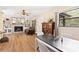 Cozy living room featuring a fireplace, built-in shelves, and dining area with stylish table setting at 14100 Ne 46Th St, Silver Springs, FL 34488