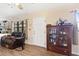 Inviting living room featuring hardwood flooring, a display cabinet, and a cozy seating area at 14100 Ne 46Th St, Silver Springs, FL 34488