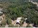 Aerial view of the property showcasing the home nestled among mature trees and greenery at 14415 County Road 448, Tavares, FL 32778