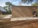 View of the metal garage and driveway leading to the building and house at 14415 County Road 448, Tavares, FL 32778