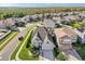 Aerial view of suburban home with manicured lawn and trees with view of forested area at 14842 Cedar Branch Way, Orlando, FL 32824