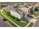 Aerial view of a home with manicured lawn and landscaping and view of a small lake at 14842 Cedar Branch Way, Orlando, FL 32824