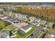 An aerial view of the neighborhood, with views of the trees and the lake in the distance at 14842 Cedar Branch Way, Orlando, FL 32824