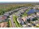 Aerial view of neighborhood with pond surrounded by green trees and manicured lawns at 14842 Cedar Branch Way, Orlando, FL 32824