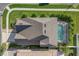 An aerial view of the roof, landscaping, and screened-in pool at 14842 Cedar Branch Way, Orlando, FL 32824