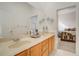 Bathroom featuring double sinks and doorway view into a bedroom at 14842 Cedar Branch Way, Orlando, FL 32824