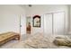 Bedroom with carpet, light walls, sliding closet, and decorative bench at 14842 Cedar Branch Way, Orlando, FL 32824