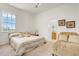 Cozy bedroom with an ensuite bathroom, lots of light, and warm neutral tones at 14842 Cedar Branch Way, Orlando, FL 32824