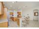 Well-lit kitchen with stainless steel appliances, light wood cabinets, and breakfast bar seating at 14842 Cedar Branch Way, Orlando, FL 32824