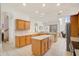 Bright open kitchen area with light wood cabinets, center island, and modern appliances at 14842 Cedar Branch Way, Orlando, FL 32824