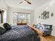 Sun-filled main bedroom showcasing a window view, hardwood floors, and a comfortable seating area at 14842 Cedar Branch Way, Orlando, FL 32824