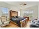 Inviting main bedroom with a grand bed frame, ceiling fan, and natural light at 14842 Cedar Branch Way, Orlando, FL 32824