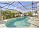 The enclosed swimming pool is surrounded by tropical trees and green landscaping at 14842 Cedar Branch Way, Orlando, FL 32824