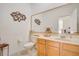 Charming powder room featuring a decorative mirror, vanity, and tiled floors at 14842 Cedar Branch Way, Orlando, FL 32824