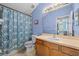 Bright bathroom featuring a patterned shower curtain, toilet and vanity with sink at 16705 Rolling Green Dr, Clermont, FL 34714