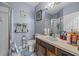 Bathroom featuring blue walls, shower, vanity with sink, toilet, mirror, and tile floor at 16705 Rolling Green Dr, Clermont, FL 34714