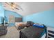 Bedroom featuring blue walls, carpeting, ceiling fan, and multiple beds at 16705 Rolling Green Dr, Clermont, FL 34714