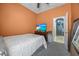 Bedroom with orange walls, carpet and a view into the bathroom at 16705 Rolling Green Dr, Clermont, FL 34714