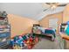 This bedroom offers carpet flooring, vaulted ceilings, ceiling fan and window at 16705 Rolling Green Dr, Clermont, FL 34714