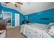 Bedroom featuring blue walls, carpet and a view into the office and Primary bathroom at 16705 Rolling Green Dr, Clermont, FL 34714