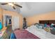 This bedroom boasts carpet, sloped ceilings, ceiling fan, dresser and television at 16705 Rolling Green Dr, Clermont, FL 34714