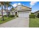 Charming two-story home with well-manicured landscaping and a two car garage at 16705 Rolling Green Dr, Clermont, FL 34714