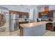 Eat-in kitchen with stainless steel appliances, tile floor, and ample countertop space at 16705 Rolling Green Dr, Clermont, FL 34714