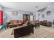 Inviting living room with tile flooring, comfortable seating, and natural light at 16705 Rolling Green Dr, Clermont, FL 34714