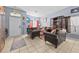 Cozy living room with comfortable seating, bright window light, and tile floors in this welcoming home at 16705 Rolling Green Dr, Clermont, FL 34714