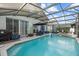 Inviting pool and spa with a screened enclosure, perfect for outdoor relaxation at 16705 Rolling Green Dr, Clermont, FL 34714