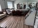 Interior shot of a recreation room with hardwood floors, a table, and comfortable seating at 16705 Rolling Green Dr, Clermont, FL 34714