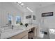 Bathroom featuring double sinks, white counters, and a view of the outdoors at 16726 Hidden Spring Dr, Clermont, FL 34714