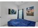 Bedroom featuring a TV, window with curtains, and a blue bedspread at 16726 Hidden Spring Dr, Clermont, FL 34714