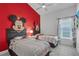 The bedroom has a playful theme with two twin beds, custom decor, and a window at 16726 Hidden Spring Dr, Clermont, FL 34714