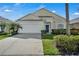 Charming single-Gathering home with a well-manicured lawn, mature landscaping, and a two-car garage at 16726 Hidden Spring Dr, Clermont, FL 34714