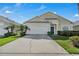 Charming single-Gathering home showcasing a well-maintained lawn, attached garage, and manicured front yard at 16726 Hidden Spring Dr, Clermont, FL 34714