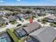 Aerial view of home featuring screened-in pool and partial view of a manicured lawn at 16739 Hidden Spring Dr, Clermont, FL 34714