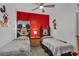 Inviting bedroom with Mickey and Minnie Mouse themed decor and red accent wall at 16739 Hidden Spring Dr, Clermont, FL 34714