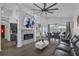 Bright living room featuring a stone fireplace, high ceilings, and views of the pool through large windows at 16739 Hidden Spring Dr, Clermont, FL 34714