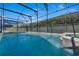 Screened pool with blue water, tile details, and ample natural light at 16739 Hidden Spring Dr, Clermont, FL 34714