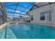 Enclosed swimming pool area with patio furniture and clear blue water at 16739 Hidden Spring Dr, Clermont, FL 34714