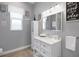 Bright bathroom with a white vanity, modern fixtures, and stylish decor that creates a clean and relaxing atmosphere at 1679 E County Road 462, Wildwood, FL 34785