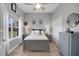 Serene bedroom with neutral tones, hardwood floors, and natural light from a window at 1679 E County Road 462, Wildwood, FL 34785