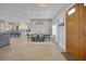 Bright dining room with open floor plan to the kitchen and a view of the front door at 1679 E County Road 462, Wildwood, FL 34785