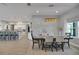 Dining room with modern chandelier, table set for six, and open concept design at 1679 E County Road 462, Wildwood, FL 34785