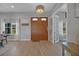 Home entryway showcasing a double door entry, decorative lighting, and adjacent rooms at 1679 E County Road 462, Wildwood, FL 34785