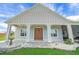 Inviting front porch with stone accents, a double door, and decorative light fixtures at 1679 E County Road 462, Wildwood, FL 34785